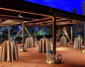 Outdoor event pavilion featuring covered gathering space, ambient lighting, and an elegant setting for receptions, celebrations, and social events at DoubleTree by Hilton Westborough.