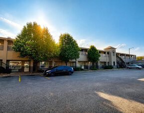 Exterior view of the hotel showcasing convenient parking, easy room access, and a welcoming setting for travelers visiting Wichita at Blue Way Inn & Suites Wichita East.