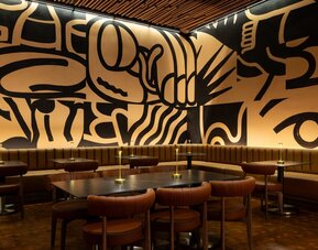 Unique dining and gathering space featuring bold artistic design, modern seating, and a vibrant atmosphere at Row NYC.