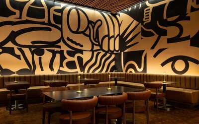 Unique dining and gathering space featuring bold artistic design, modern seating, and a vibrant atmosphere at Row NYC.