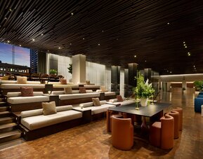 Elegant lobby area featuring contemporary décor, comfortable seating, and open spaces designed for relaxation and social interaction at Row NYC.