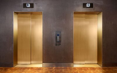 Modern elevator area featuring contemporary finishes and convenient access to guest accommodations and hotel amenities at Row NYC.
