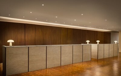 Modern reception desk featuring streamlined check-in services, contemporary design, and a welcoming atmosphere for guests arriving at Row NYC.