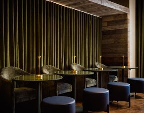 Intimate lounge seating area featuring plush furnishings, ambient lighting, and a sophisticated setting for relaxation or casual meetings at Row NYC.