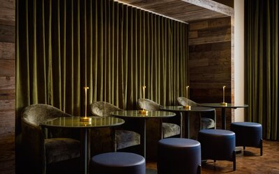 Intimate lounge seating area featuring plush furnishings, ambient lighting, and a sophisticated setting for relaxation or casual meetings at Row NYC.