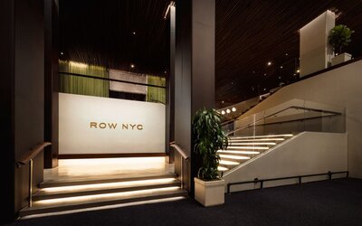 Interior stairway showcasing modern design, illuminated steps, and sophisticated architectural details within Row NYC.