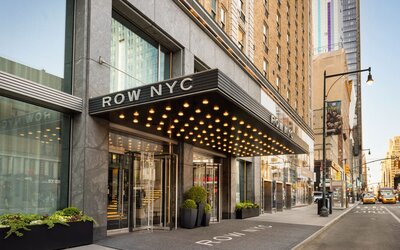 Street-level entrance of Row NYC featuring signature marquee lighting, modern architecture, and a welcoming arrival experience in New York City.