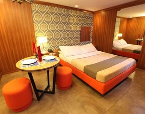 King room with red color theme at Victoria Court Hillcrest.