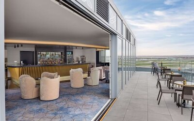 Outdoor chairs near the bar at Hilton Garden Inn London Heathrow Terminals 2 And 3.