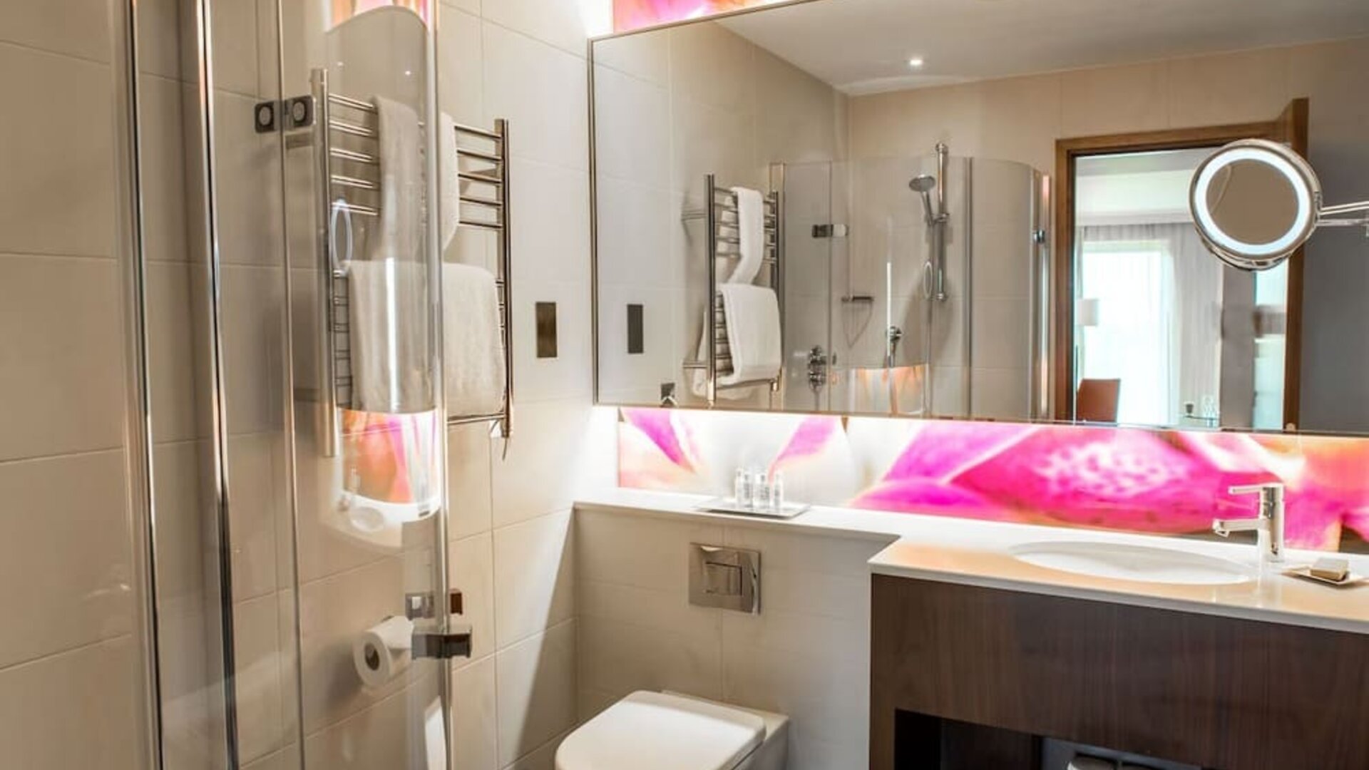 Guest bathroom with shower at Hilton London Heathrow Airport Terminal 5. 