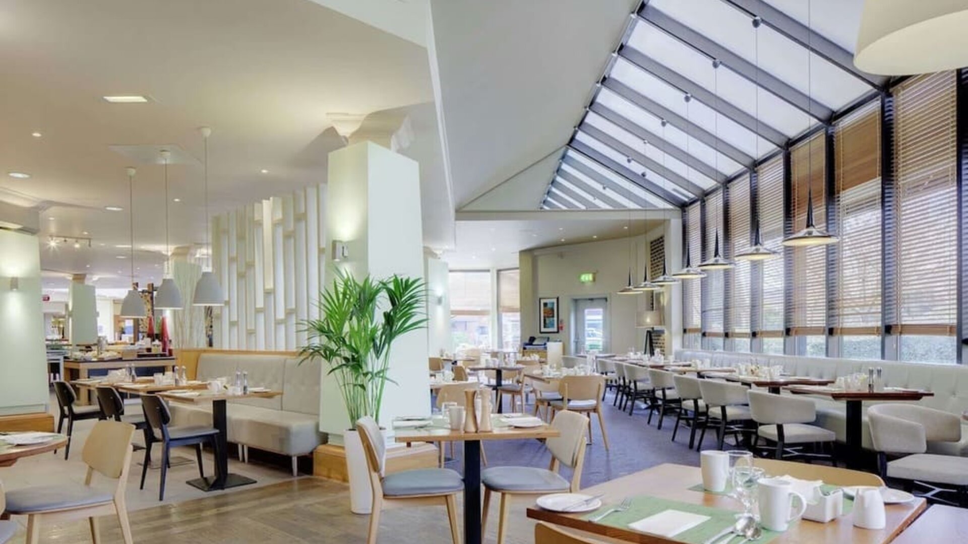 Spacious dining room with natural light at DoubleTree By Hilton Manchester Airport.