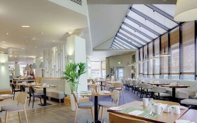 Spacious dining room with natural light at DoubleTree By Hilton Manchester Airport.