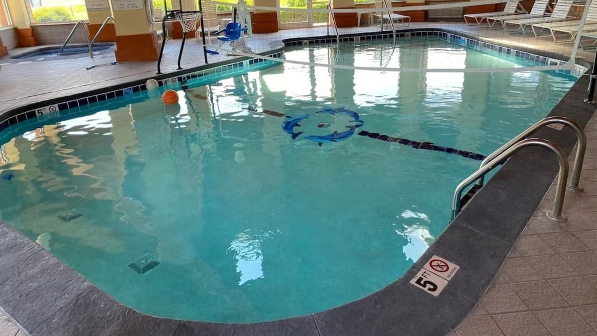 Indoor pool with natural light at Baymont By Wyndham Pella.