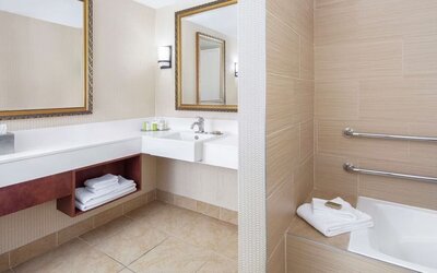 Guest bathroom with tub at DoubleTree By Hilton Sunrise.