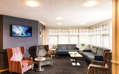 Lobby and coworking lounge at Leonardo Inn Aberdeen Airport.
