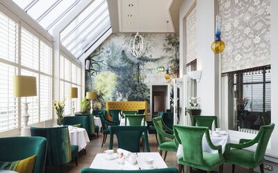 Modern dining area with high ceiling and natural light at The Grand Brighton.