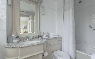 Guest bathroom with shower and tub at The Grand Brighton. 
