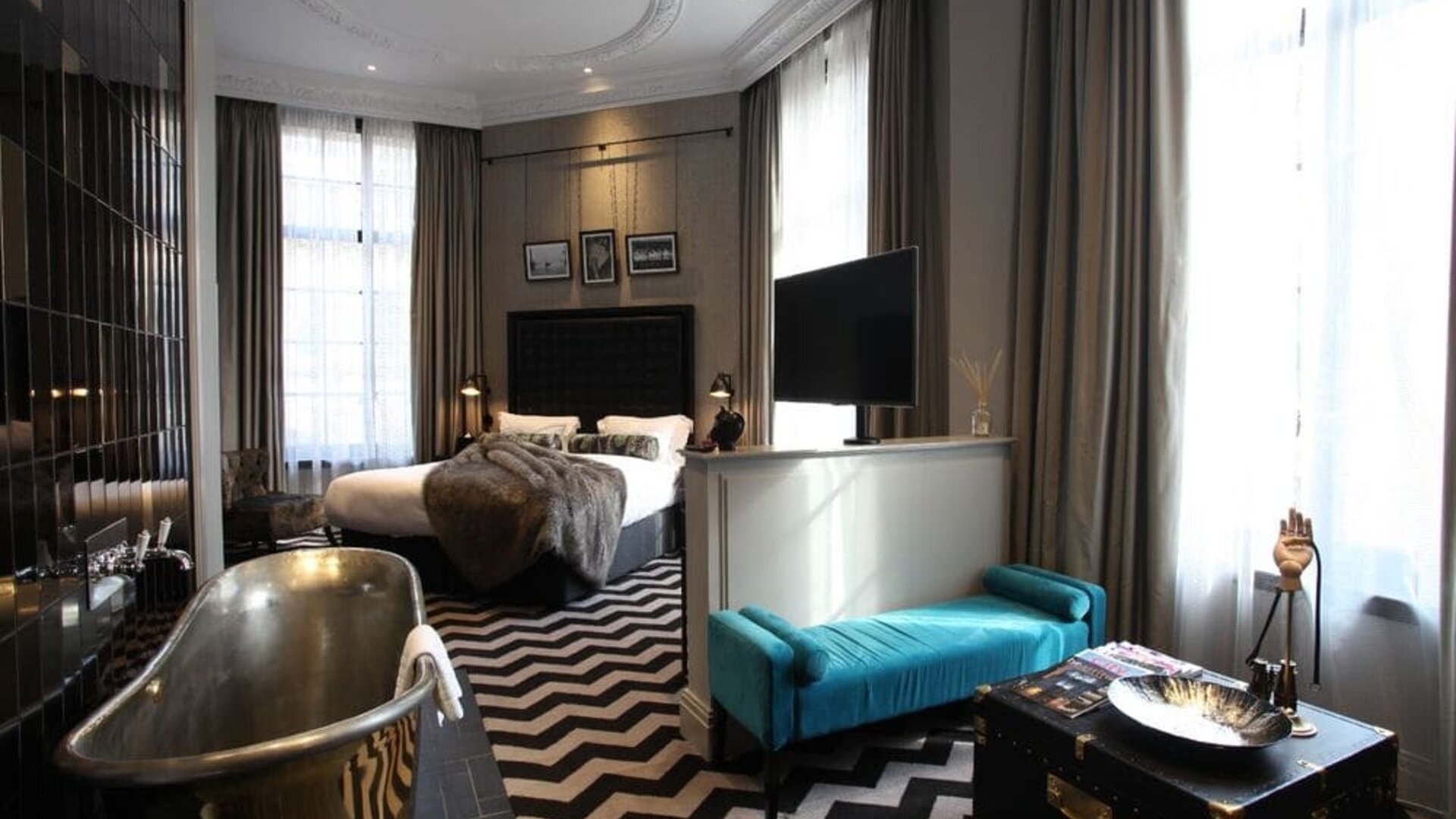 Day use room with high ceilings and deep soaking bathtub at Hotel Gotham. 
