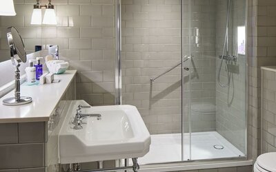 Guest bathroom with shower at The Midland - A Leonardo Royal Hotel.