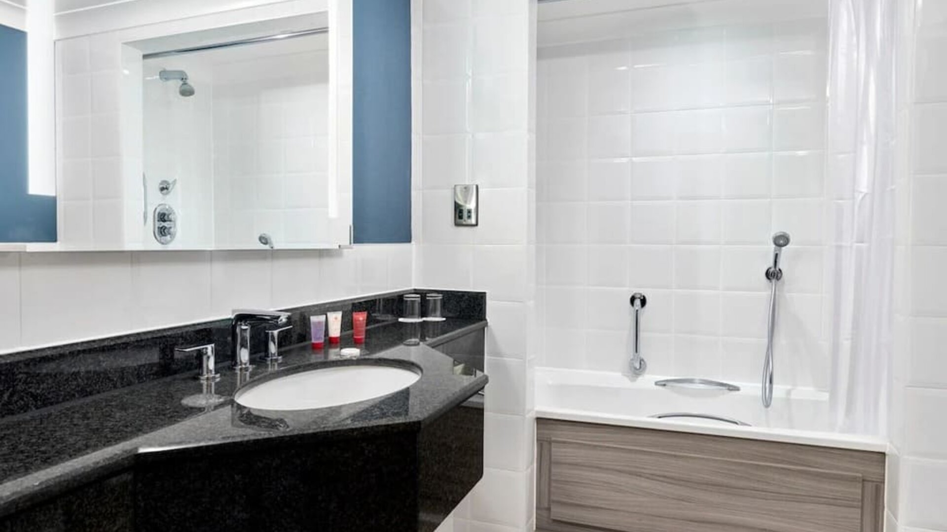Guest bathroom with shower and tub at Leonardo Hotel Southampton Grand Harbour.