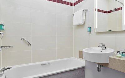 Guest bathroom with shower and tub at Leonardo Hotel Sheffield.