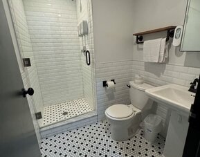 Guest bathroom with shower at Tribeca Hotel FiDi.
