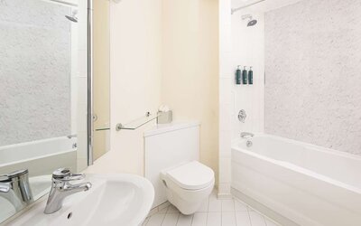 Guest bathroom with shower and tub at Hilton Northampton.