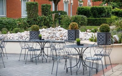 Seats and tables available in the garden at Hilton Northampton.