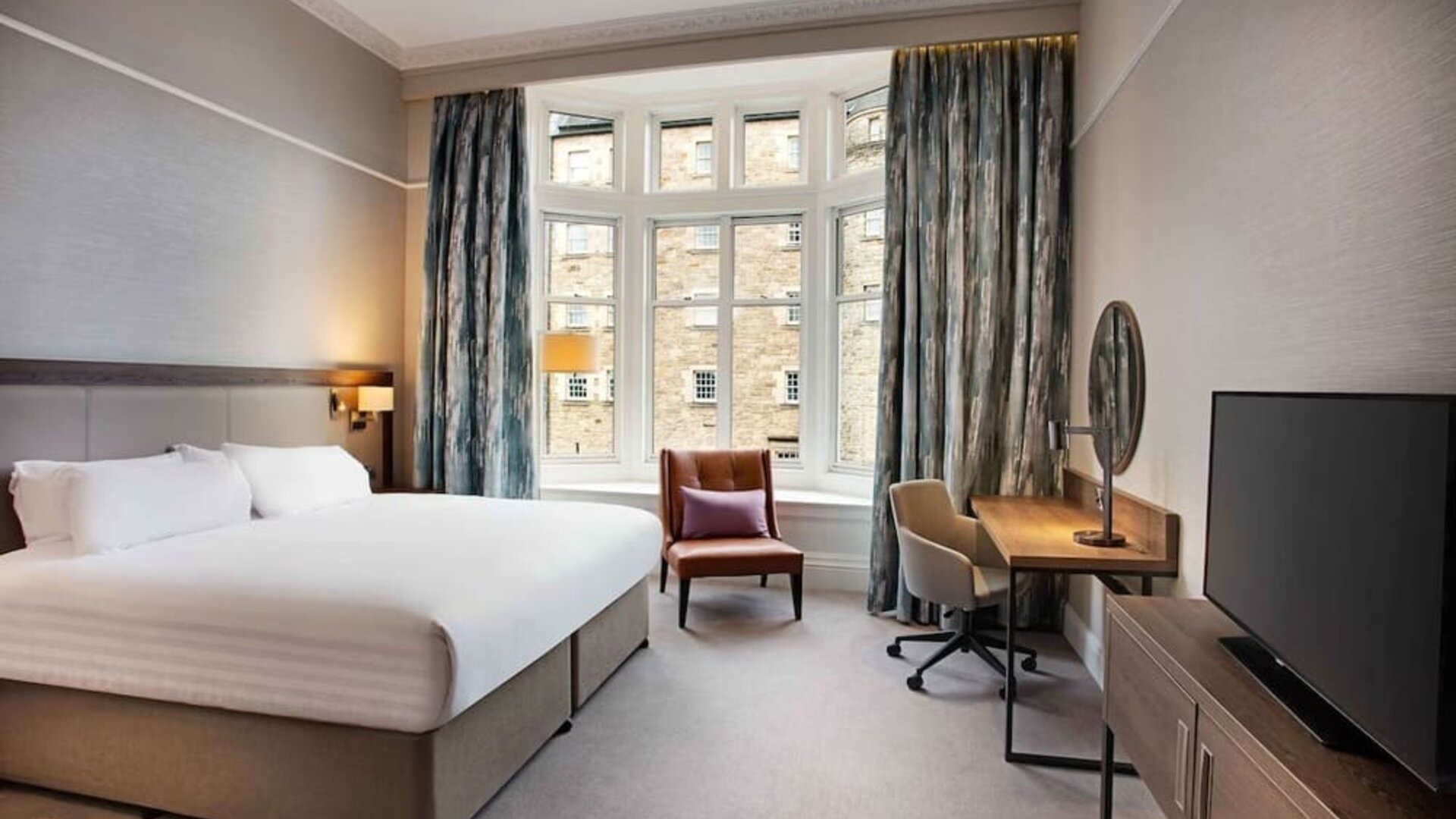King bedroom with large window at Hilton Edinburgh Carlton.