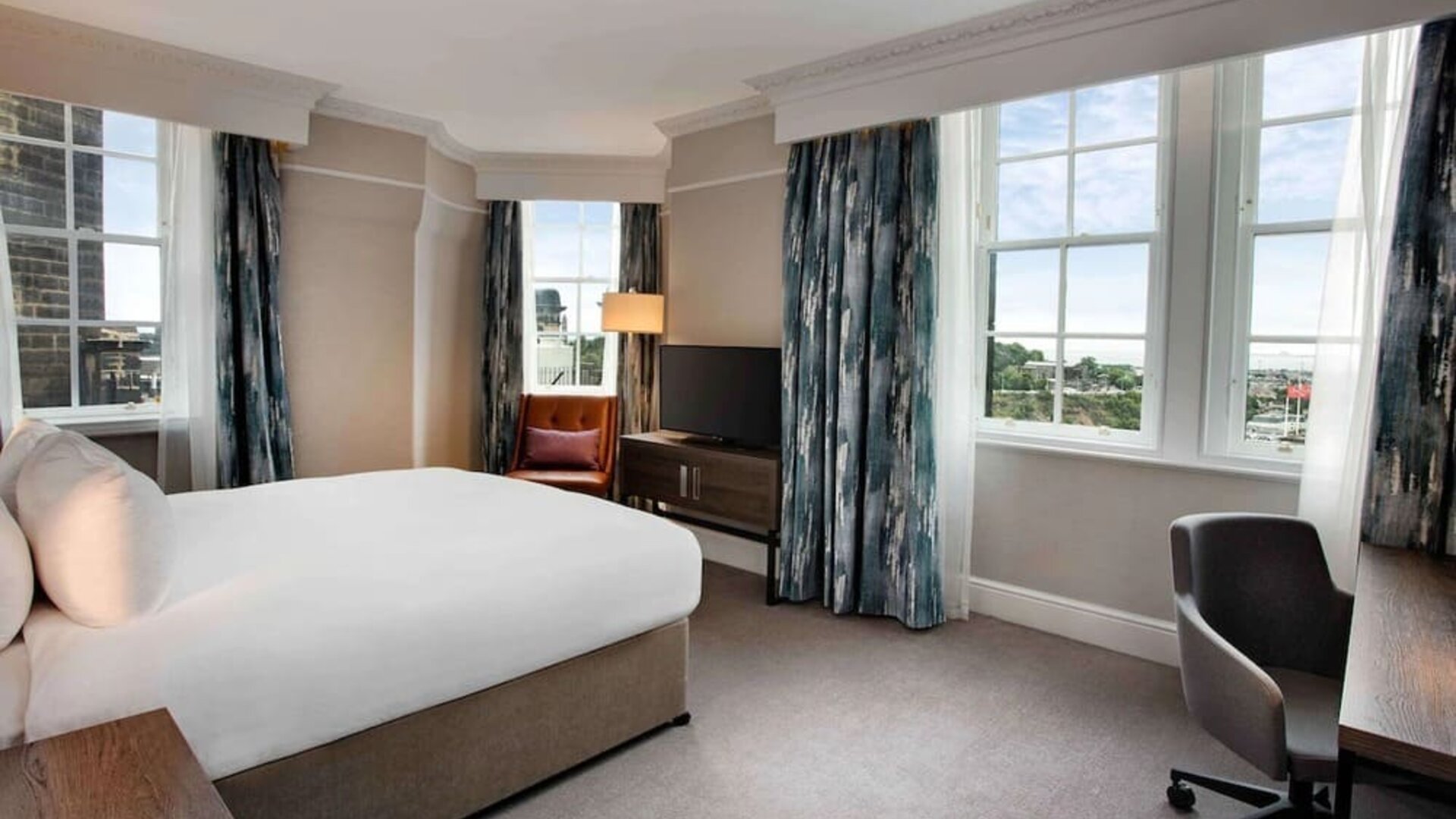 Day use room with large windows and work desk at Hilton Edinburgh Carlton.