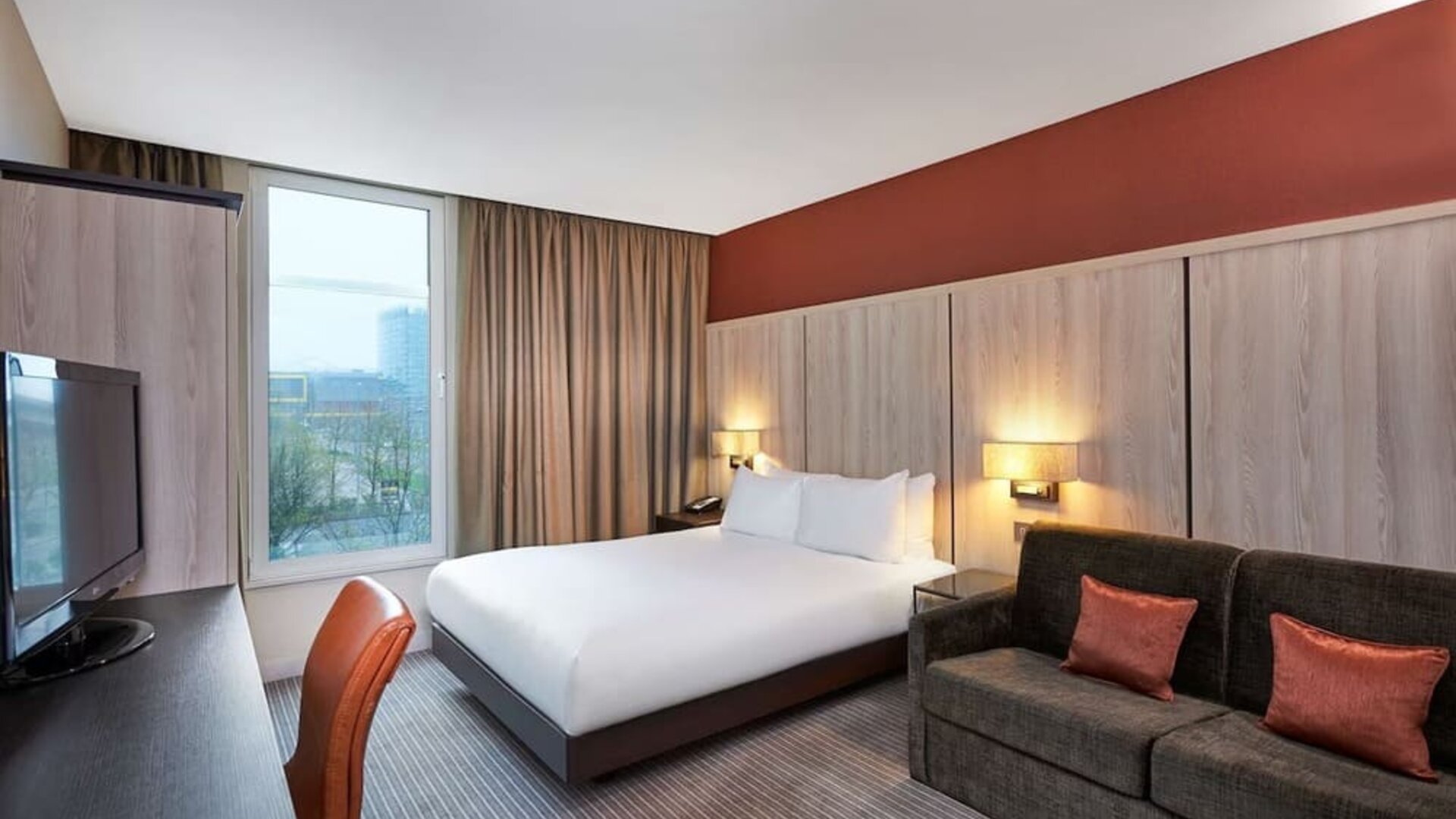Day use room with sofa and large window at DoubleTree By Hilton London Excel.