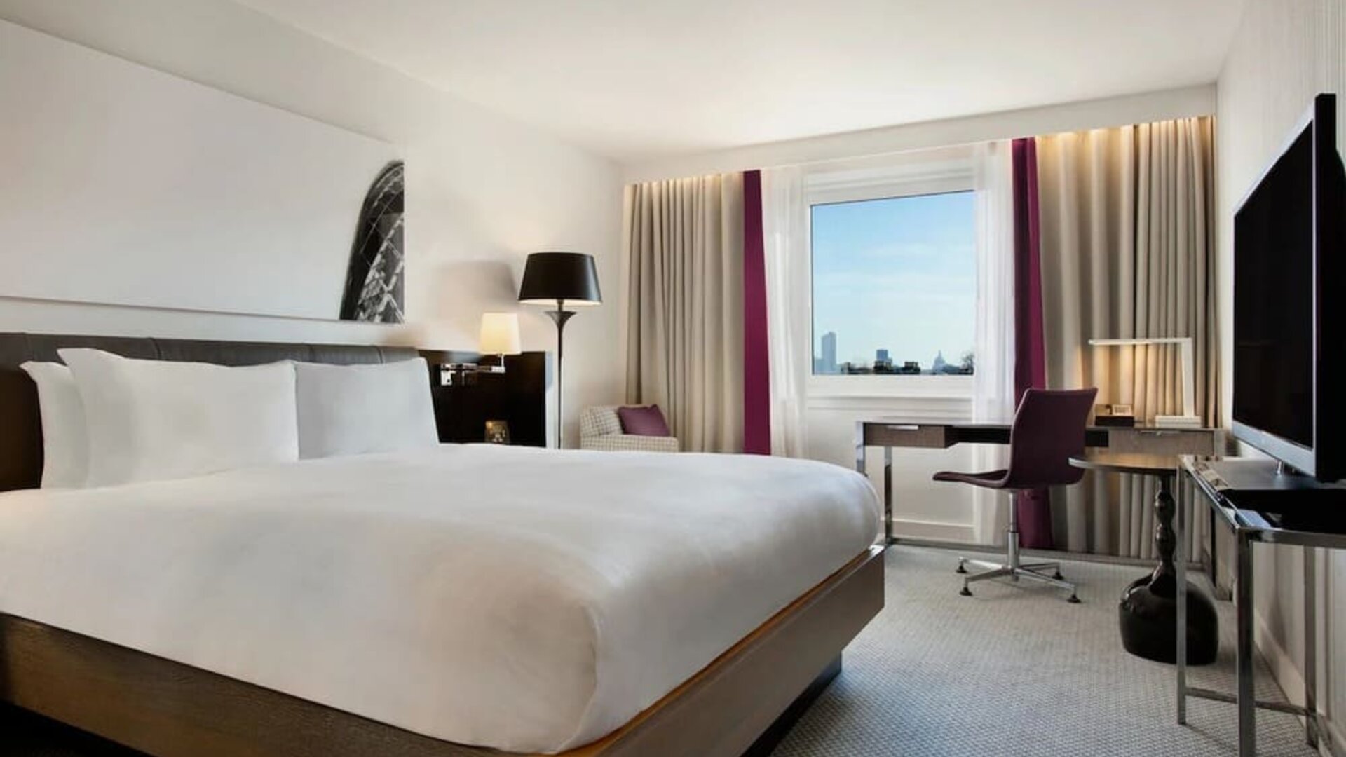 Delux king bed with work desk at Hilton London Angel Islington.
