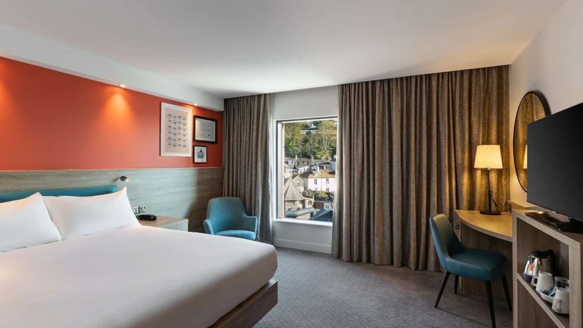 Luxurious king suite with TV and work desk at Hampton By Hilton Torquay.