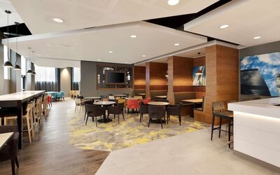 Lobby workspace with tables and chairs at the Hampton by Hilton London Docklands.