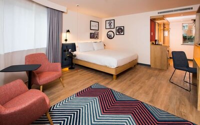 Comfortable king room with work desk and coffee station at Hampton By Hilton London Park Royal.