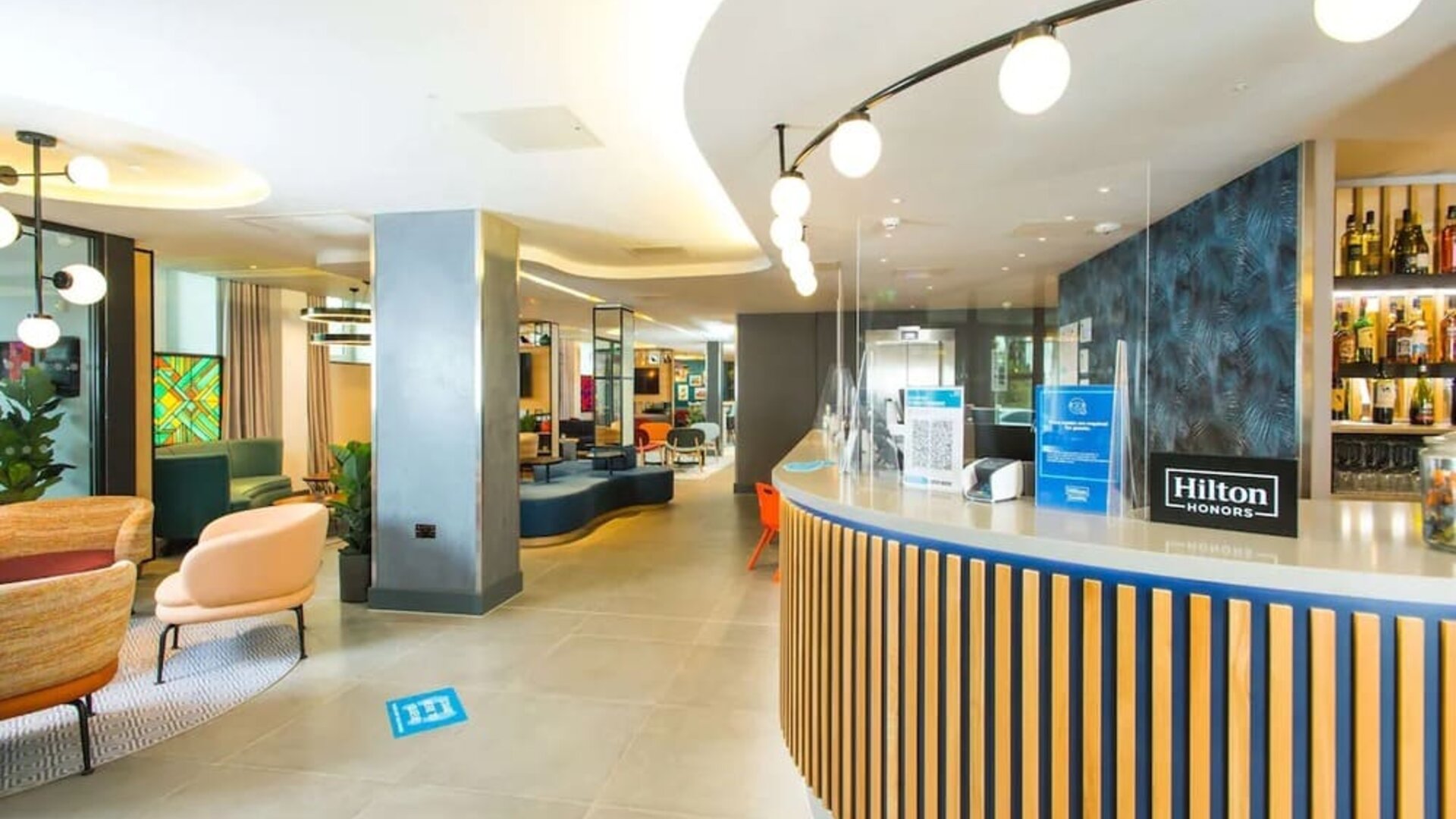 Lobby and coworking lounge at Hampton By Hilton London Park Royal.