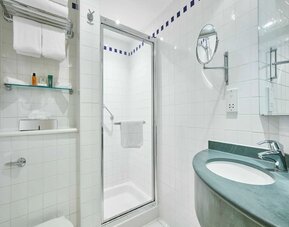 Guest bathroom with shower and toiletries at the Hilton Garden Inn Birmingham Brindleyplace.