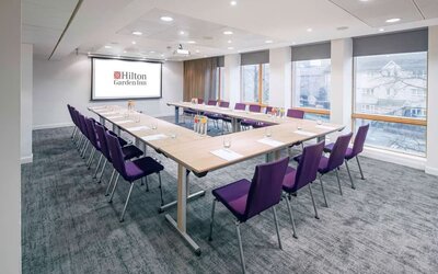 Spacious meeting room with comfortable mobiliary and large windows at the Hilton Garden Inn Birmingham Brindleyplace.