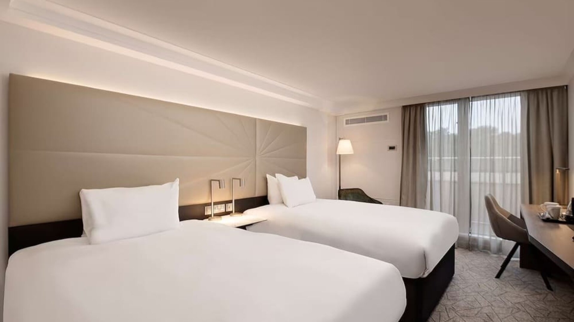 Twin room with work desk and big windows at the Hilton Birmingham Metropole.