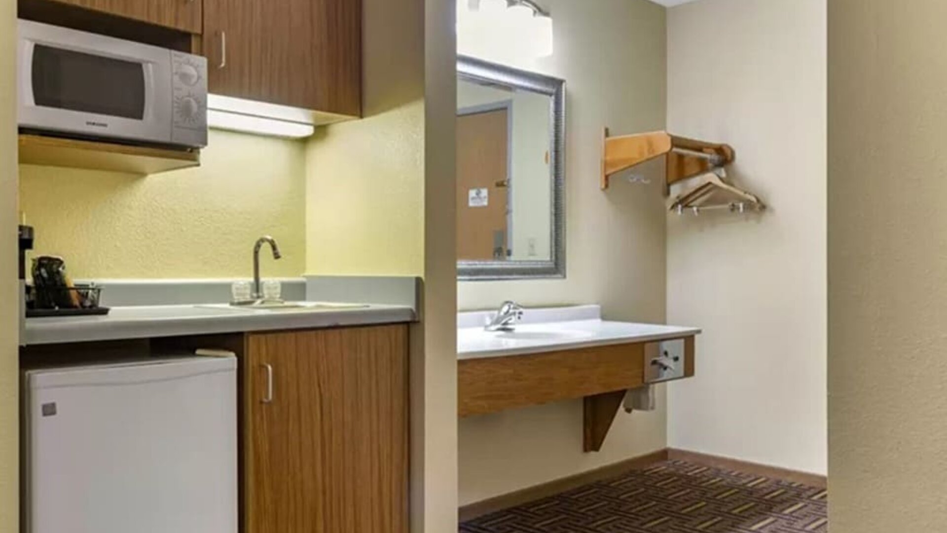 Guest bathroom and kitchen area at Coratel Inn & Suites By Jasper River Falls.
