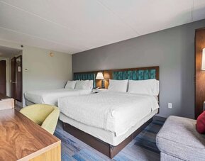 Double Queen guest room featuring two comfortable beds, modern furnishings, ample workspace, and thoughtful amenities for families or groups at Hampton Inn Ridgefield Park.