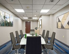 Meeting room featuring a professional boardroom setup, comfortable seating, and modern facilities for business meetings and small group events.