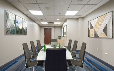 Meeting room featuring a professional boardroom setup, comfortable seating, and modern facilities for business meetings and small group events.