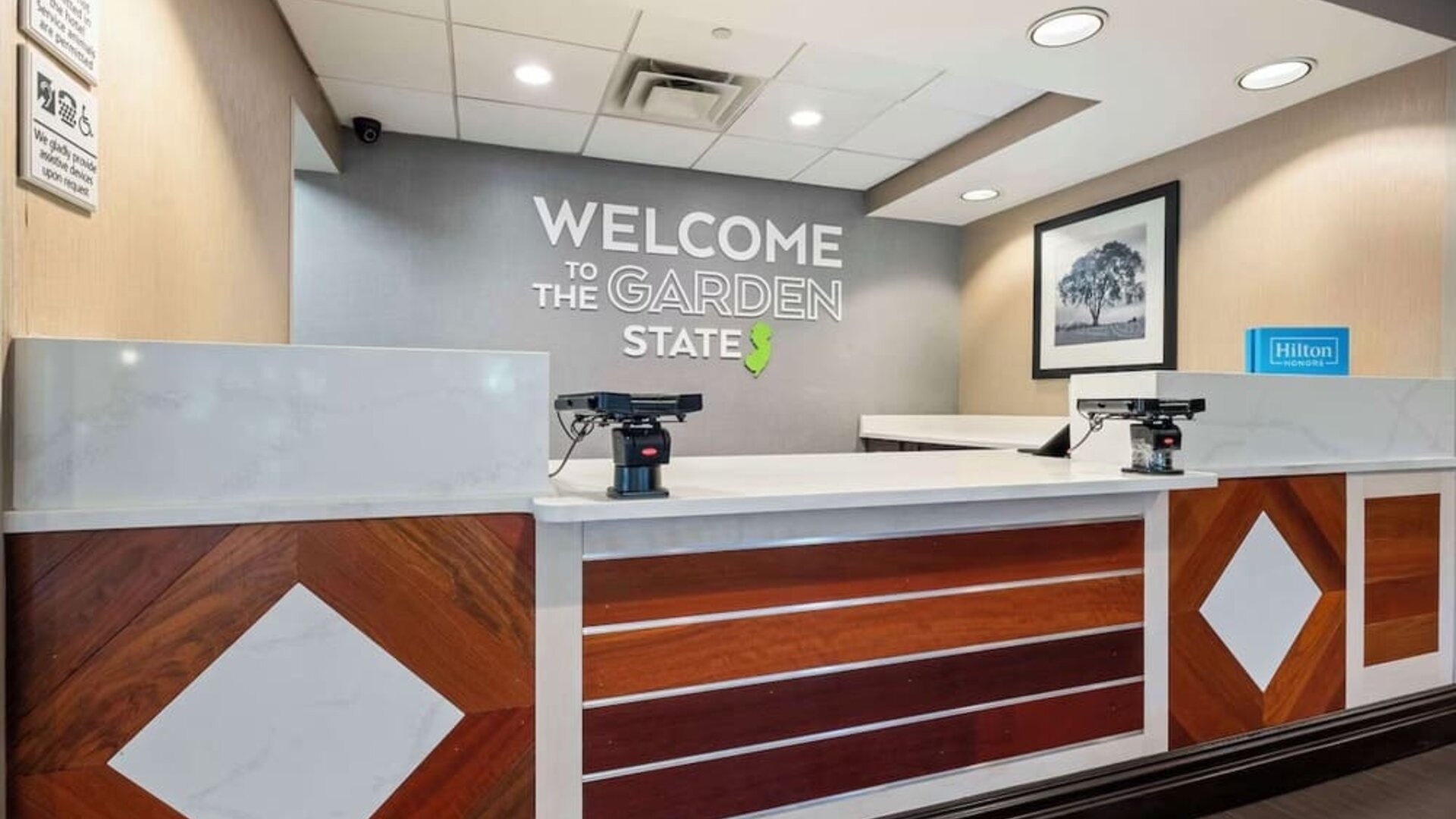 Modern reception desk featuring friendly check-in services and a welcoming lobby atmosphere at Hampton Inn Ridgefield Park.