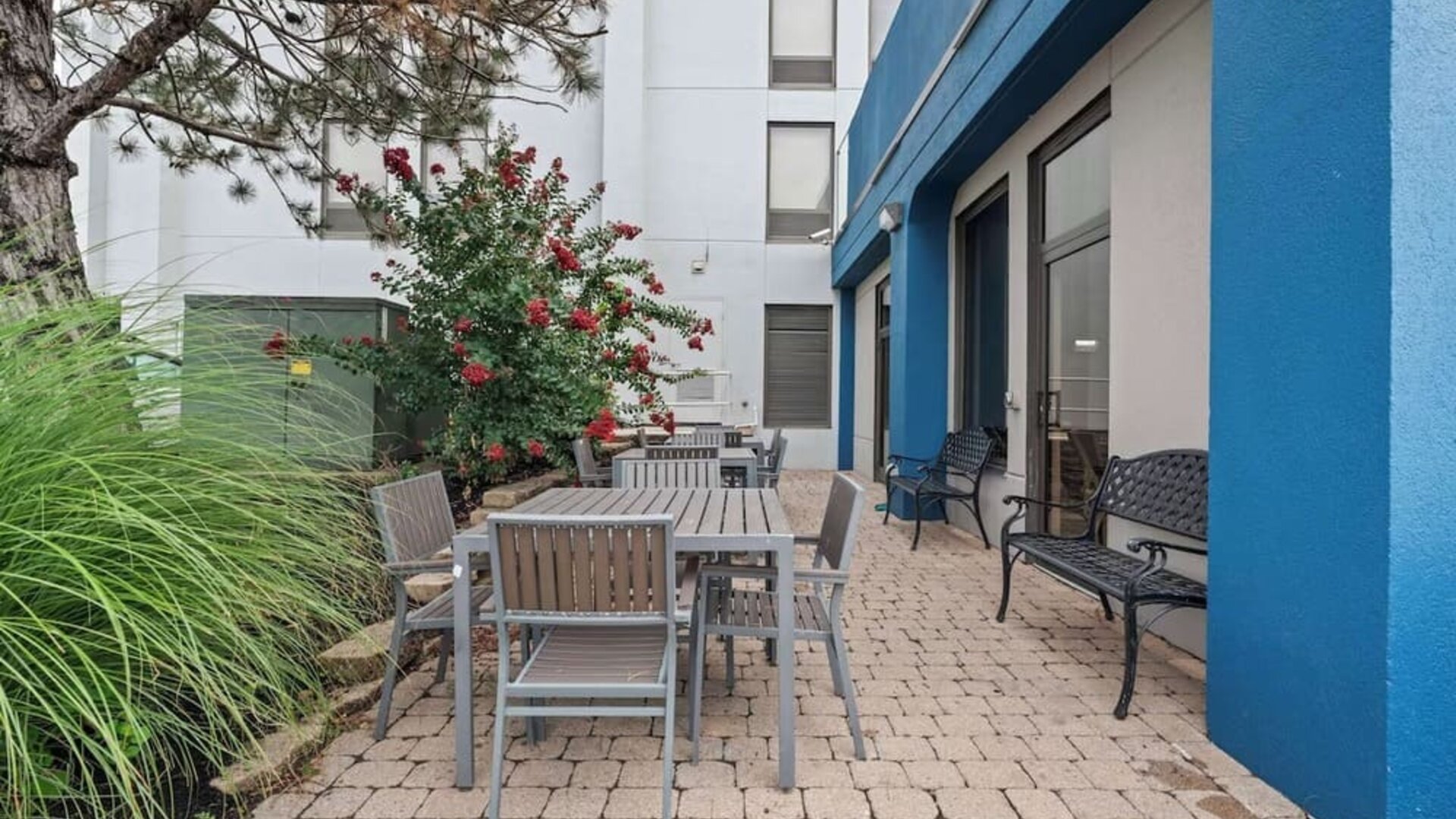 Outdoor patio featuring comfortable seating, landscaped surroundings, and a peaceful space to relax and unwind at Hampton Inn Ridgefield Park.