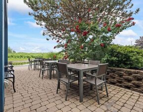 Outdoor terrace offering patio seating, lush landscaping, and a tranquil setting for enjoying fresh air during your stay at Hampton Inn Ridgefield Park.