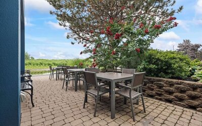 Outdoor terrace offering patio seating, lush landscaping, and a tranquil setting for enjoying fresh air during your stay at Hampton Inn Ridgefield Park.