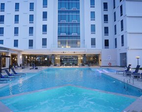 Expansive outdoor pool complex with sun loungers, cabanas, and resort-style amenities available to guests at Crowne Plaza Panama Airport.
