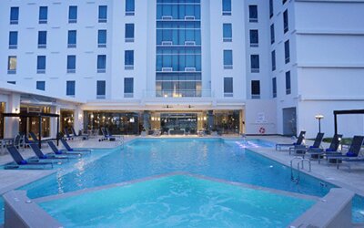 Expansive outdoor pool complex with sun loungers, cabanas, and resort-style amenities available to guests at Crowne Plaza Panama Airport.