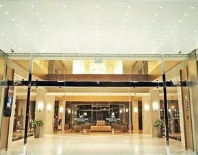 Elegant hotel lobby entrance with high ceilings, polished finishes, and a welcoming reception area at Crowne Plaza Panama Airport.